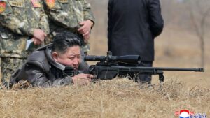 This picture shows North Korean leader Kim Jong Un (C) looking through a rifle scope as he visits a training base of the Korean People's Army's special operations forces to observe a comprehensive training session, North Korea, April 5, 2025. (AFP Photo)