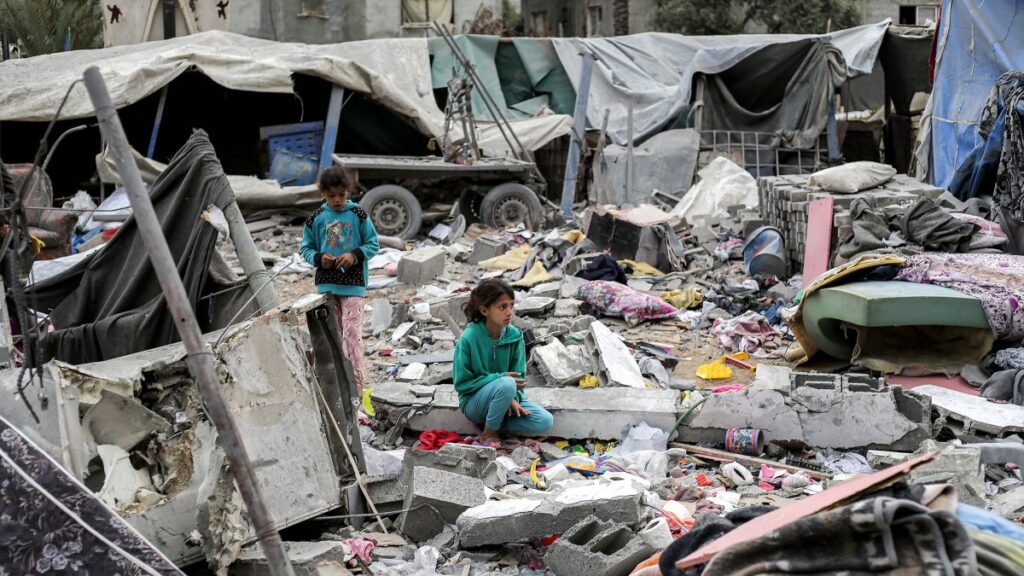 A girl sits by the rubble outside the Sabah family building that was hit by Israeli airstrikes in Deir el-Balah in the central Gaza Strip, April 8, 2025. (AFP Photo)