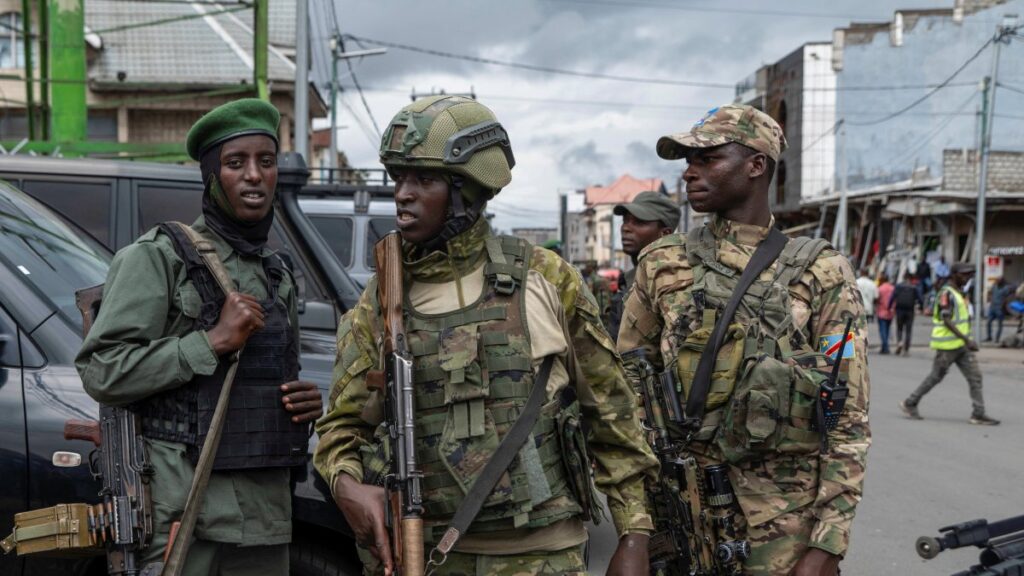 Members of the M23 rebel group stand guard at the opening ceremony of the General Savings Bank of Congo (CADECO), which will serve as the bank for the city of Goma where all banks have closed since the city was taken by the M23 rebels, Goma, North Kivu province, DRC, April 7, 2025. (Reuters Photo)