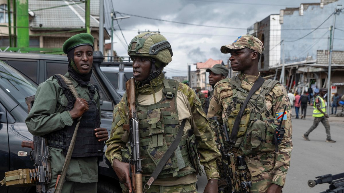 Members of the M23 rebel group stand guard at the opening ceremony of the General Savings Bank of Congo (CADECO), which will serve as the bank for the city of Goma where all banks have closed since the city was taken by the M23 rebels, Goma, North Kivu province, DRC, April 7, 2025. (Reuters Photo)