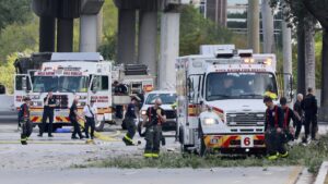 Emergency personnel respond to the area where a small plane crashed on the railroad tracks beneath the overpass near Interstate 95 in Boca Raton, Fla., on Friday, April 11, 2025. (Mike Stocker /South Florida Sun-Sentinel via AP)