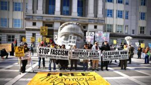 People hold signs as they attend a protest in support of Columbia University student activist Mahmoud Khalil while a hearing takes place outside the court in Newark, New Jersey on March 28, 2025. (AFP File Photo)