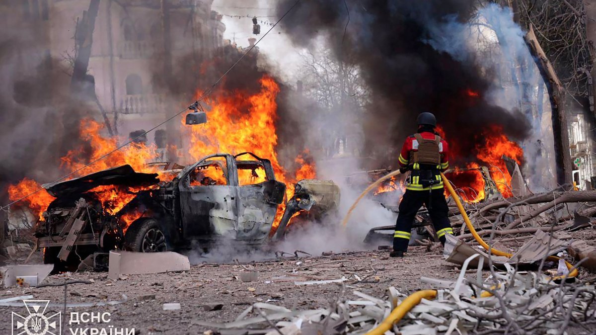 A Ukrainian rescuer works to extinguish a fire at the site of a missile attack in Sumy, northeastern Ukraine, April 13, 2025. (AFP Photo)