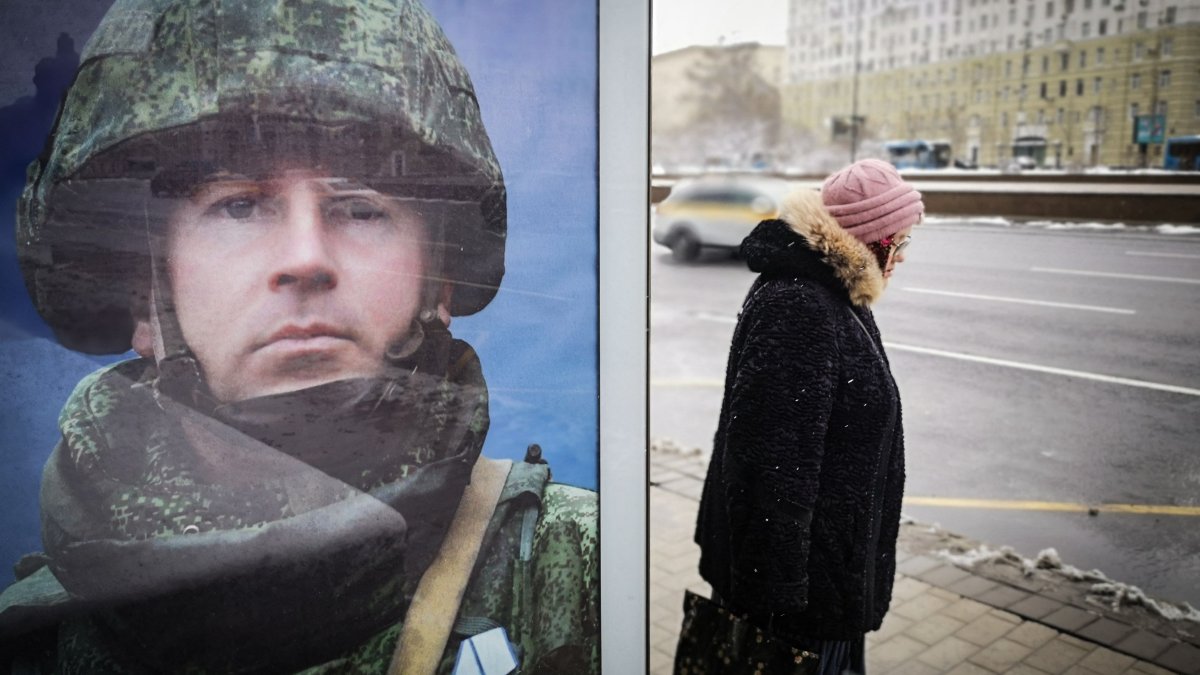 A woman walks past a poster promoting contract army service in western Moscow, Russia, April 9, 2025. (AFP Photo)