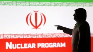 A 3D-printed miniature model depicting U.S. President Donald Trump, Iran flag and a word "Nuclear program" in this illustration taken, April 17, 2025. (Reuters Photo)