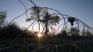 A cross is seen behind razor wire in the frontline town of Kostiantynivka, in Donetsk region, Ukraine, April 19, 2025. (Reuters Photo)