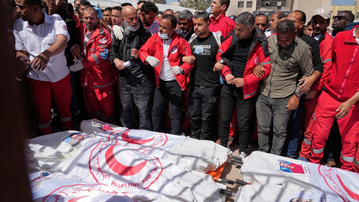 Mourners gather around the bodies of 8 Red Crescent emergency responders, recovered in Rafah a week after an Israeli attack, as they are transported for burial from a hospital, Deir al-Balah, Gaza Strip, March 31, 2025. (AP Photo)