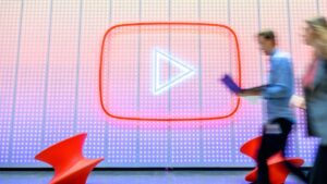 People walk by a YouTube logo, as Google celebrates the 20th anniversary of first video uploaded to YouTube, at the company's corporate headquarters in San Bruno, California, U.S., April 23, 2025. (AFP Photo)