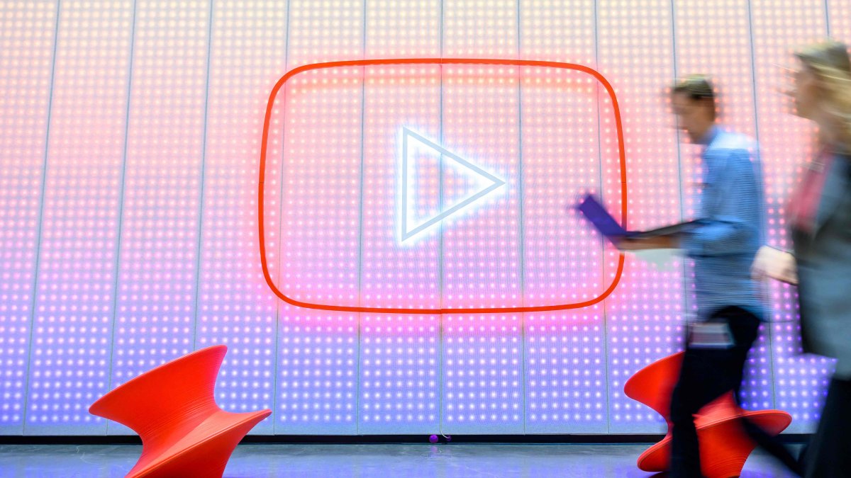 People walk by a YouTube logo, as Google celebrates the 20th anniversary of first video uploaded to YouTube, at the company's corporate headquarters in San Bruno, California, U.S., April 23, 2025. (AFP Photo)