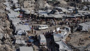 Displaced Palestinians gather at a market near the rubble of destroyed buildings in Jabalia, northern Gaza Strip, April 27, 2025. (EPA Photo)