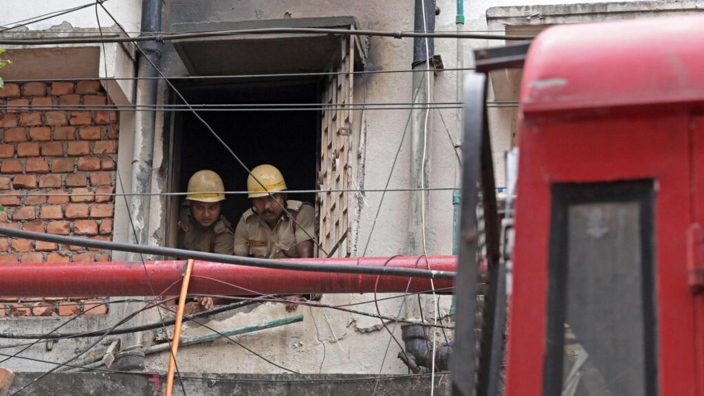 Firefighters inspect the Rituraj Hotel where a fire broke out, in Kolkata, West Bengal, India, April 30, 2025. (AFP Photo)