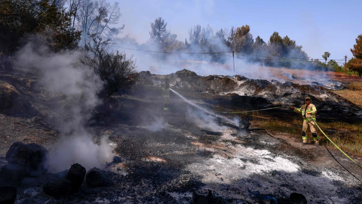 An Israeli firefighter extinguishes a forest fire near Latrun Monastery in central Israel, May 1, 2025. (AFP Photo)
