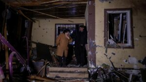 Residents stand near a building damaged by a Russian drone strike, amid Russia's attack on Ukraine, in Kharkiv, Ukraine, May 3, 2025. (Reuters Photo)