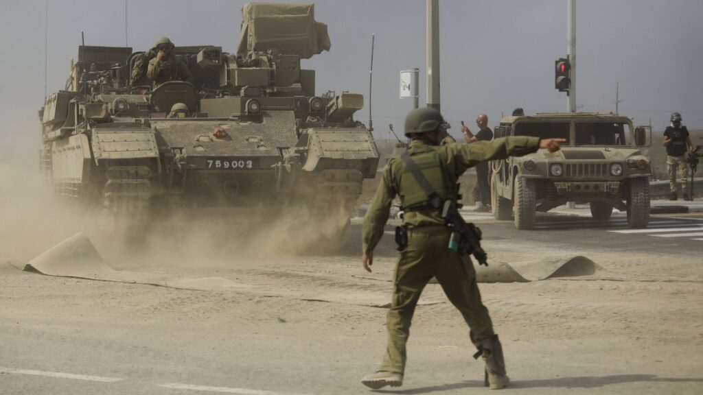 An Israeli soldier gives directions to a tank unit near the border with Gaza, Palestine, Oct. 14, 2023. (Getty Images)