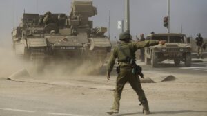 An Israeli soldier gives directions to a tank unit near the border with Gaza, Palestine, Oct. 14, 2023. (Getty Images)