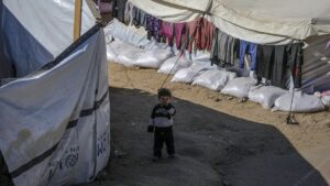 An internally displaced Palestinian child stands outside his family's tent in Al Yarmouk stadium in central Gaza City, the Gaza Strip, Palestine, May 5, 2025. (EPA Photo)