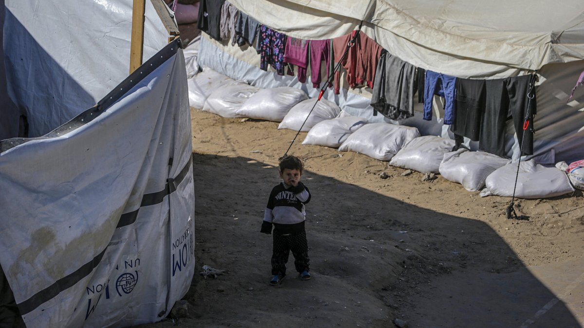 An internally displaced Palestinian child stands outside his family's tent in Al Yarmouk stadium in central Gaza City, the Gaza Strip, Palestine, May 5, 2025. (EPA Photo)