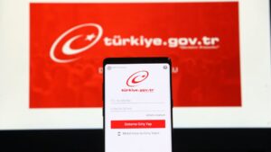 The e-Government Gateway website displayed on a laptop and smartphone screen, Istanbul, Türkiye. (Shutterswtcok Photo)