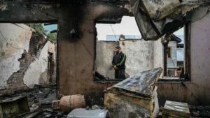 A man stands inside his house destroyed by Pakistani artillery shelling at the Salamabad village, Uri, Kashmir, May 8, 2025. (AFP Photo)