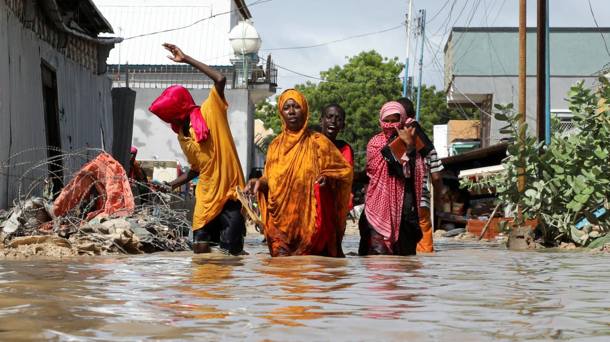 A Somali family wades through flood waters, as they flee after overnight rains destroyed their home, in Wadajir district, Mogadishu, Somalia, May 10, 2025. (Reuters Photo)