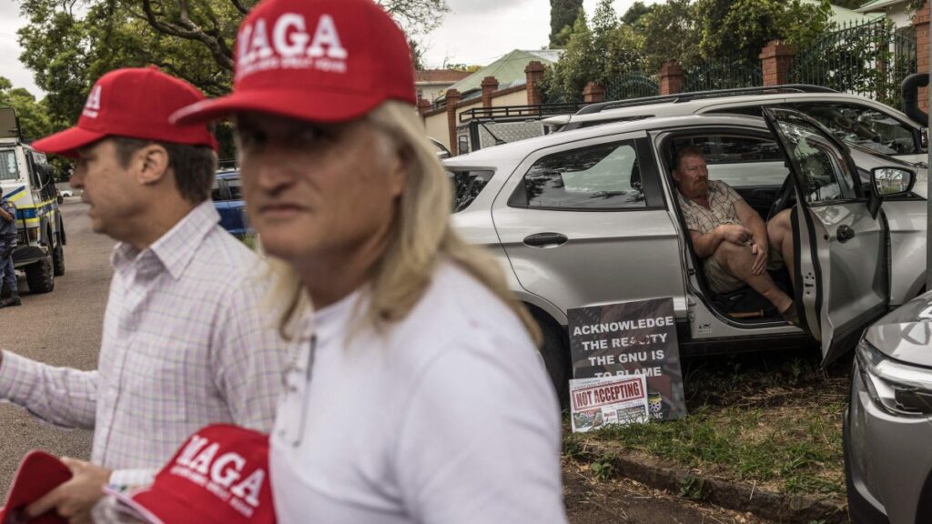 A man wears a Make Afrikaners Great Again (MAGA) cap in reference to the American MAGA as white South Africans supporting U.S. President Donald Trump and South African and US tech billionaire Elon Musk gather in front of the U.S. Embassy, Pretoria, Feb. 15, 2025. (AFP Photo)