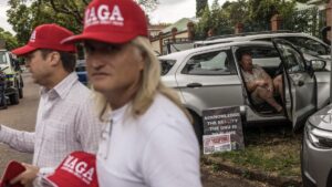 A man wears a Make Afrikaners Great Again (MAGA) cap in reference to the American MAGA as white South Africans supporting U.S. President Donald Trump and South African and US tech billionaire Elon Musk gather in front of the U.S. Embassy, Pretoria, Feb. 15, 2025. (AFP Photo)