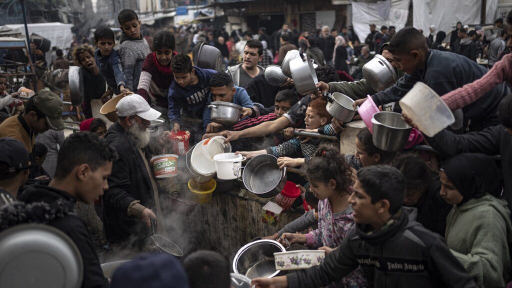 Palestinians line up for a meal in Rafah, Gaza Strip, Palestine, Dec. 21, 2023. (AP Photo)