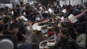 Palestinians line up for a meal in Rafah, Gaza Strip, Palestine, Dec. 21, 2023. (AP Photo)