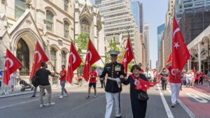 People waving at the start of the annual Turkish American Day Parade and festival, downtown Madison Avenue, New York, U.S., May 22, 2022. (Shutterstock Photo)