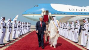 U.S. President Donald Trump (L) walks with Qatar's Emir Tamim bin Hamad Al Thani after landing at the Hamad International Airport, Doha, Qatar, May 14, 2025. (AA Photo)