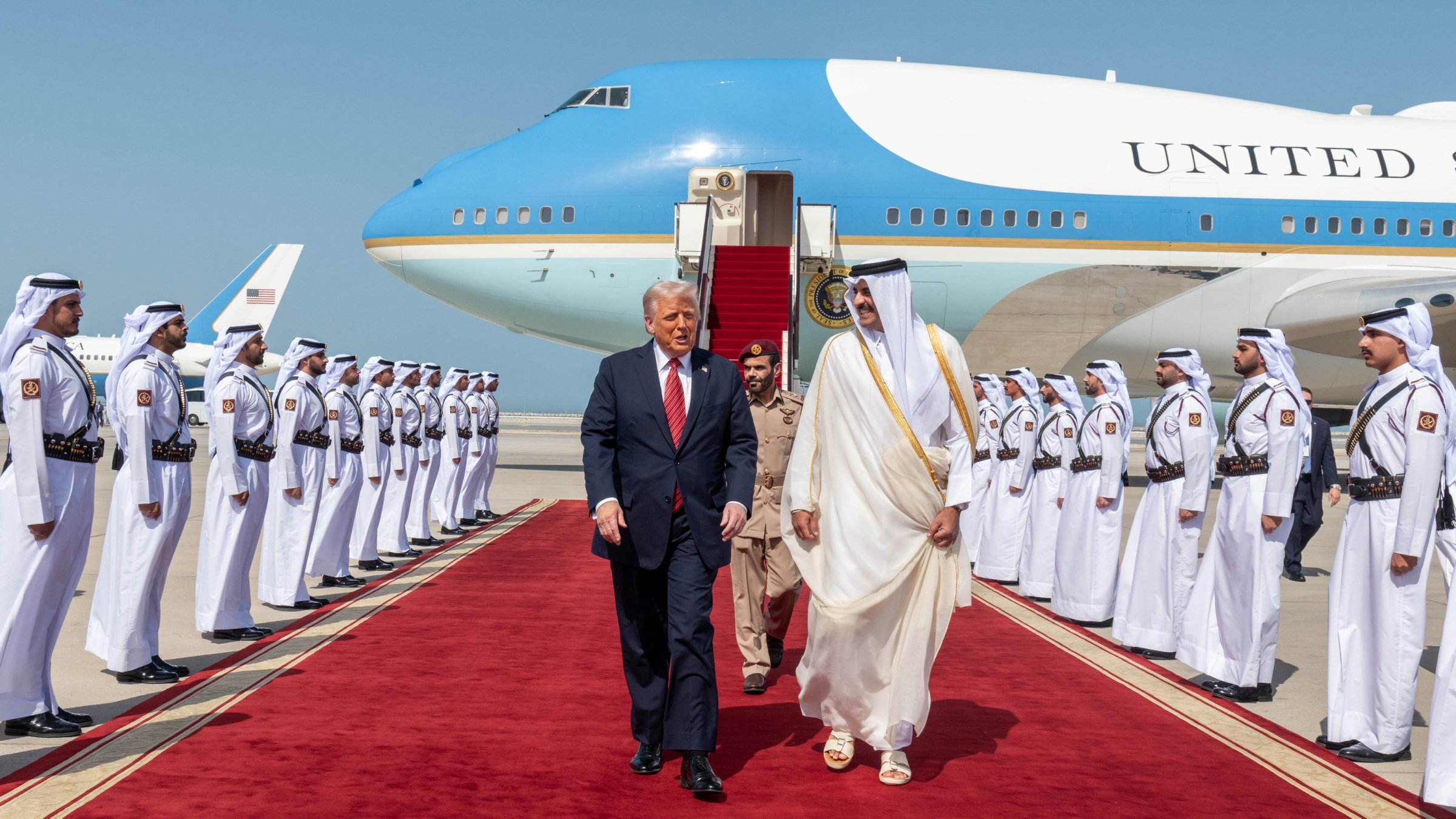U.S. President Donald Trump (L) walks with Qatar's Emir Tamim bin Hamad Al Thani after landing at the Hamad International Airport, Doha, Qatar, May 14, 2025. (AA Photo)