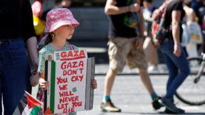 A girl holds a poster during a protest in support of Palestinians in Gaza to mark the 77th anniversary of the "Nakba", or "catastrophe", in Dublin, Ireland, May 17, 2025. (Reuters Photo)