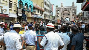 Rescue workers and police stand outside the building that caught fire in Hyderabad, India, May 18, 2025. (AFP Photo)