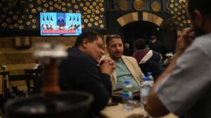 Syrians watch a speech by Syrian President Ahmad al-Sharaa at a cafe in central Damascus, Syria, May 14, 2025. (EPA Photo)