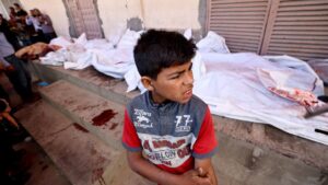 A boy gestures as he stands near the bodies of Palestinians killed in Israeli strikes, in Deir el-Balah, central Gaza Strip, Palestine, May 20, 2025. (AFP Photo)