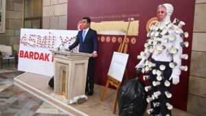 Lawmaker Osman Gökçek speaks at a news conference next to a mannequin and a sign made of paper cups, Ankara, Türkiye, May 8, 2025. (AA Photo)