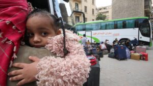 A Sudanese refugee girl looks on as other refugee families wait next their luggage at an assembly point for buses, arranged for their voluntary return from Egypt to Sudan following the Sudanese army's recapture of major swathes of the capital region of Khartoum from its foe, the paramilitary Rapid Support Forces (RSF), in Cairo, Egypt, April 11, 2025. (Reuters Photo)