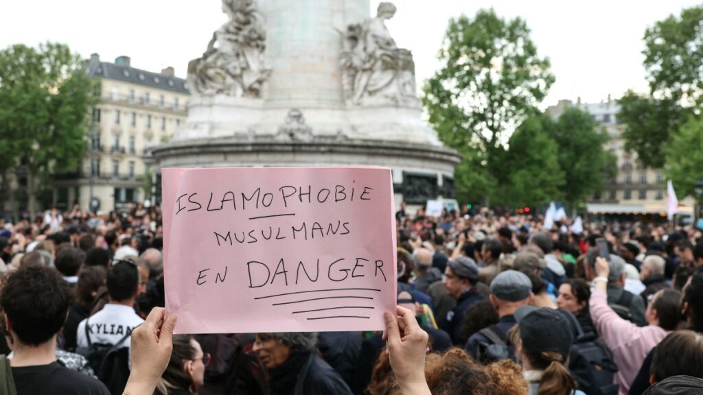 A protestor holds a sign reading "Islamophobia, Muslims in danger" during a gathering in tribute to Aboubakar, the worshipper killed in a mosque at La Grand-Combe, and against Islamophobia, at the Place de la Republique in Paris on April 27, 2025. (AFP Photo)