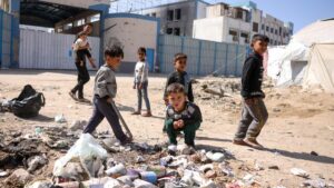 Children play around waste in front of the closed U.N. agency for Palestinian refugees (UNRWA) headquarters in Gaza City, Palestine, May 20, 2025. (AFP Photo)