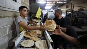 Employees of a bakery in Deir al-Balah stack freshly-baked bread after Israel allowed limited humanitarian aid to enter Gaza, Palestine, May 22, 2025. (AFP Photo)