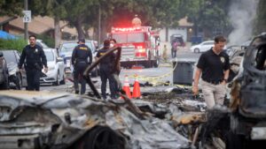Investigators look through the site where a small plane crashed into San Diego, California, residential street May 22, 2025. (AFP Photo)