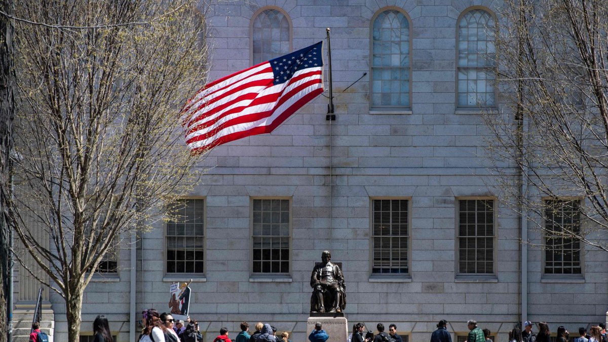 Demonstrators with signs stand around the John Harvard Statue in Harvard Yard following a rally against President Donald Trump’s attacks on Harvard University at Harvard University in Cambridge, Massachusetts, April 17, 2025. (AFP Photo)