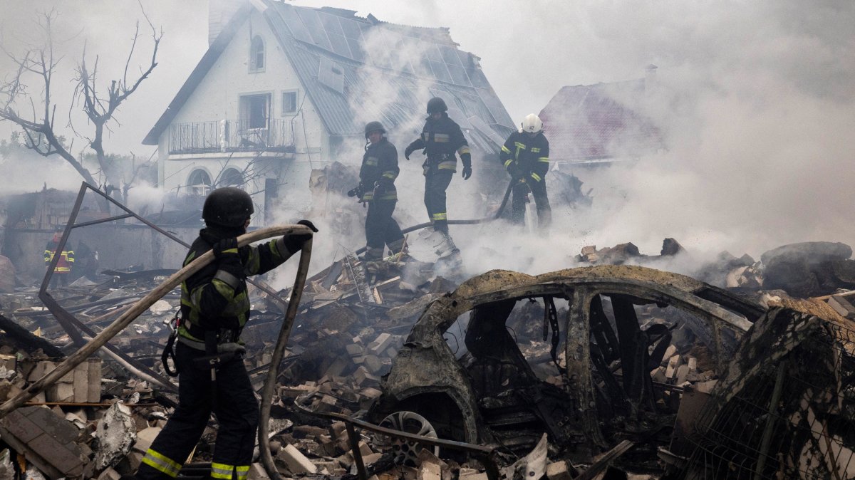 Emergency workers extinguish fire in the debris of a private house that was destroyed in a Russian rocket strike, in Markhalivka, Kyiv region, Ukraine, May 25, 2025. (Reuters Photo)