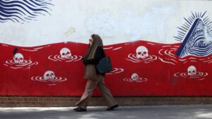 An Iranian woman walks past an anti-U.S. mural near the former U.S. embassy in Tehran, Iran, May 22, 2025. (EPA Photo)