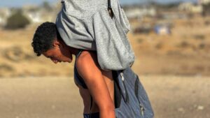 A youth walks with a package on his back as displaced Palestinians receive food packages from a U.S.-backed foundation, in western Rafah, southern Gaza Strip, Palestine, May 27, 2025. (AFP Photo)