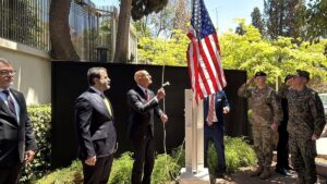 Syrian Foreign Minister Assaad al-Shibani (2nd L) looks on as U.S. special envoy for Syria Thomas Barrack raises the flag of the United States at the U.S. ambassador's residence in Damascus, Syria, May 29, 2025. (AFP Photo)