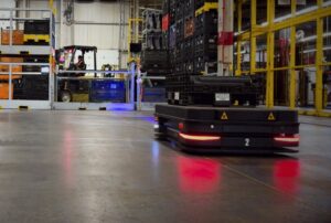 An autonomous mobile robot is seen at a factory. (Courtesy of Milvus Robotics)