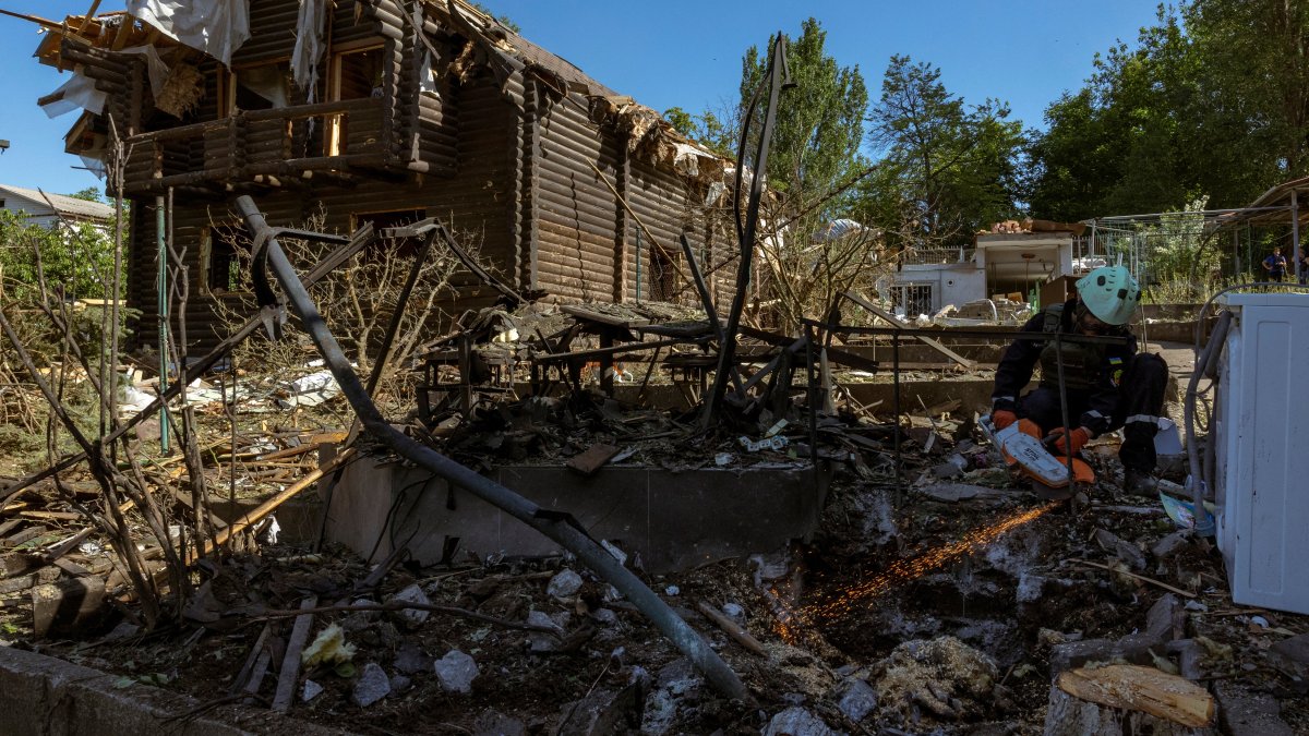 An emergency service member works at the site where Russian drones damaged several private houses, amid Russia's attack on Ukraine, Zaporizhzhia, Ukraine, June 1, 2025. (Reuters Photo)