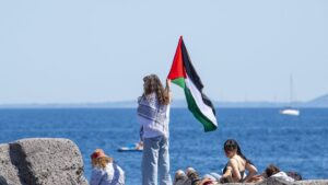Climate activist Greta Thunberg waves the Palestinian flag before boarding the Madleen departed from the port of Catania, Sicily, Italy, June 1, 2025. (AA Photo)