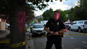 A police officer reties a tape barrier near the scene of an attack that injured multiple people, in Boulder, Colorado, U.S. June 1, 2025.  REUTERS/Mark Makela